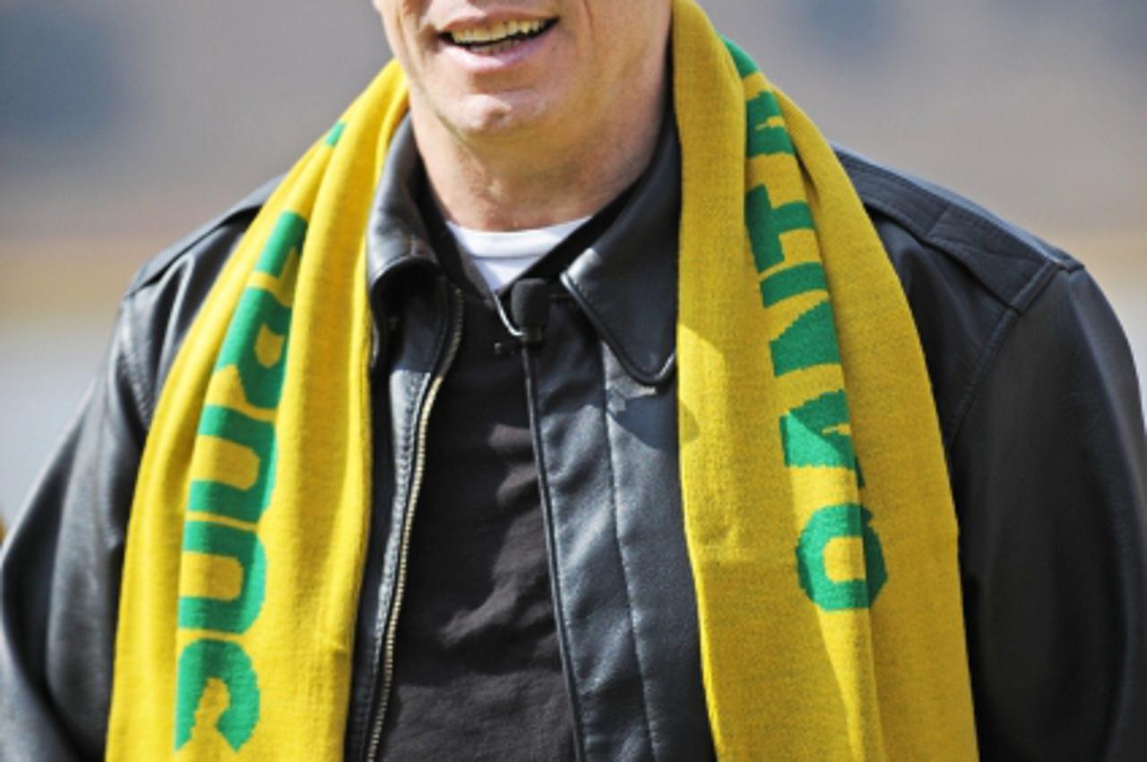 'US actor John Travolta arrives for a press conference with Australia\'s football team wearing an Australian scarf outside the team\'s hotel in Muldersdrift on June 11, 2010 ahead of the start of the 