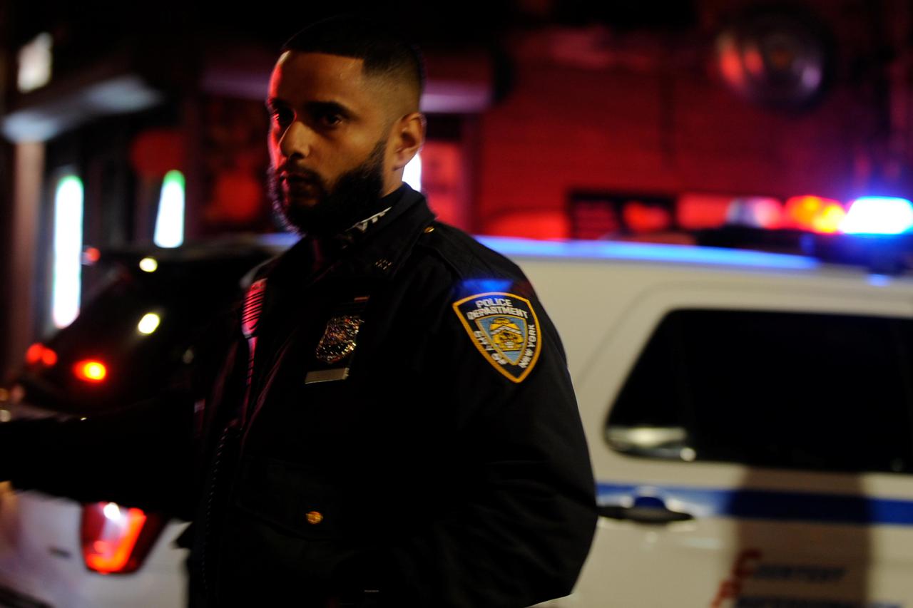 Police personnel respond to a shooting in the Brooklyn borough of New York