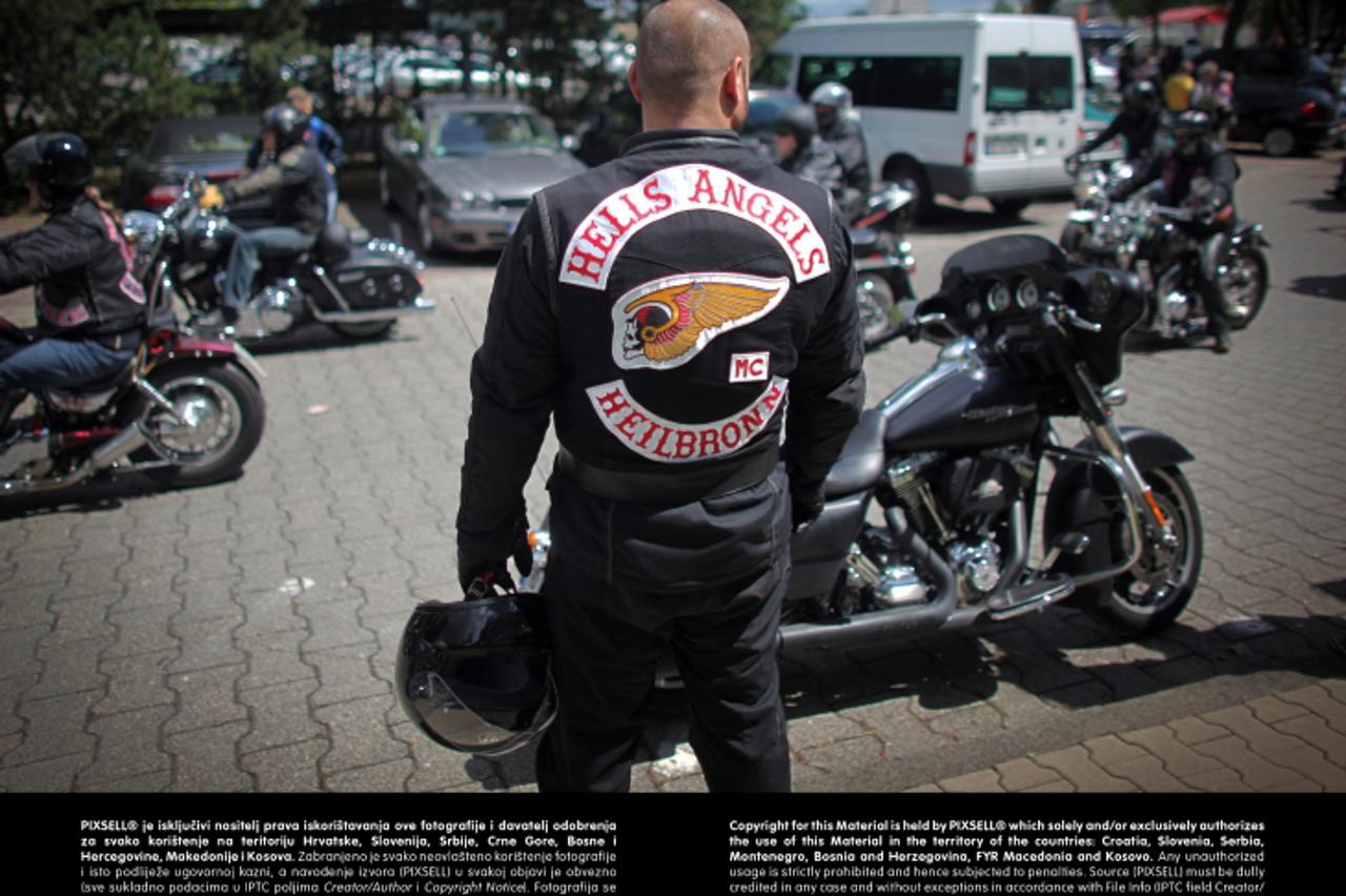 'A member of the motorcycle club Hells Angels attends a protest action in Frankfurt Main, Germany, 14 July 2012. About 300 members of motorcycle clubs initiated a motorcade through the city of Frankfu