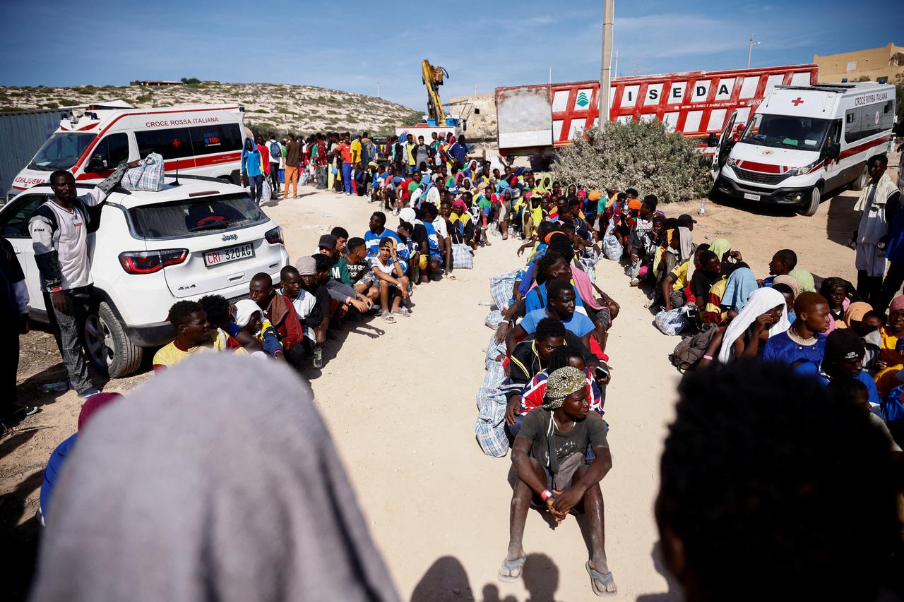 Migrants wait on the Sicilian island of Lampedusa
