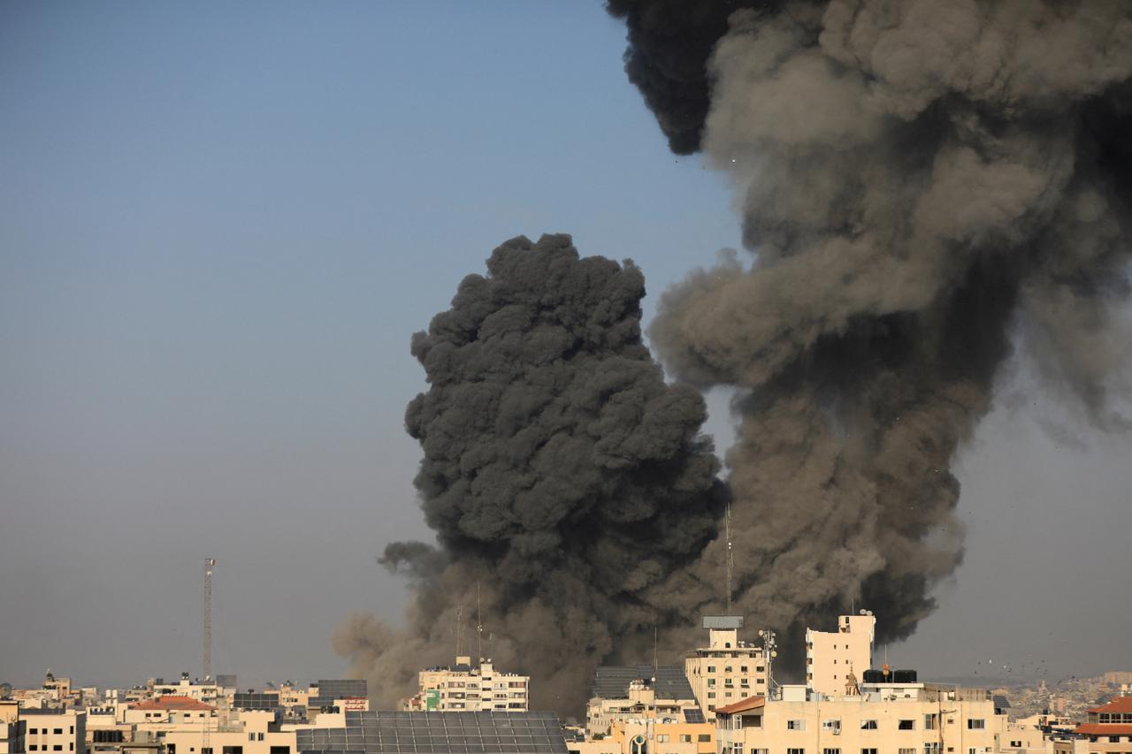 Palestinians work to rescue people at the site of an Israeli strike on a residential building in Gaza City