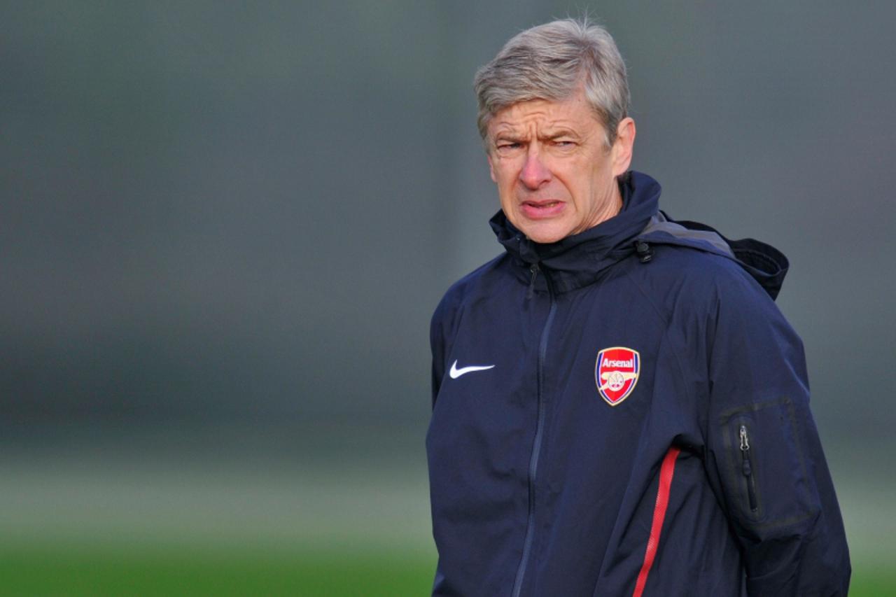 'Arsenal\'s French manager Arsene Wenger watches his players during a team training session at their training ground, in London Colney, north of London, on December 7, 2010. Arsenal are set to play Pa