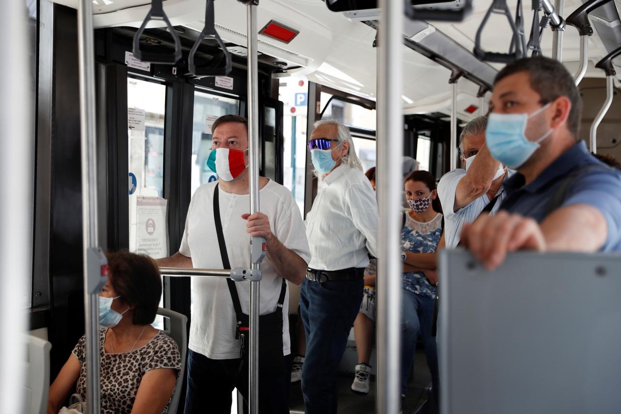 Passengers wearing protective face masks are seen while travelling on a bus, following the coronavirus disease (COVID-19) outbreak