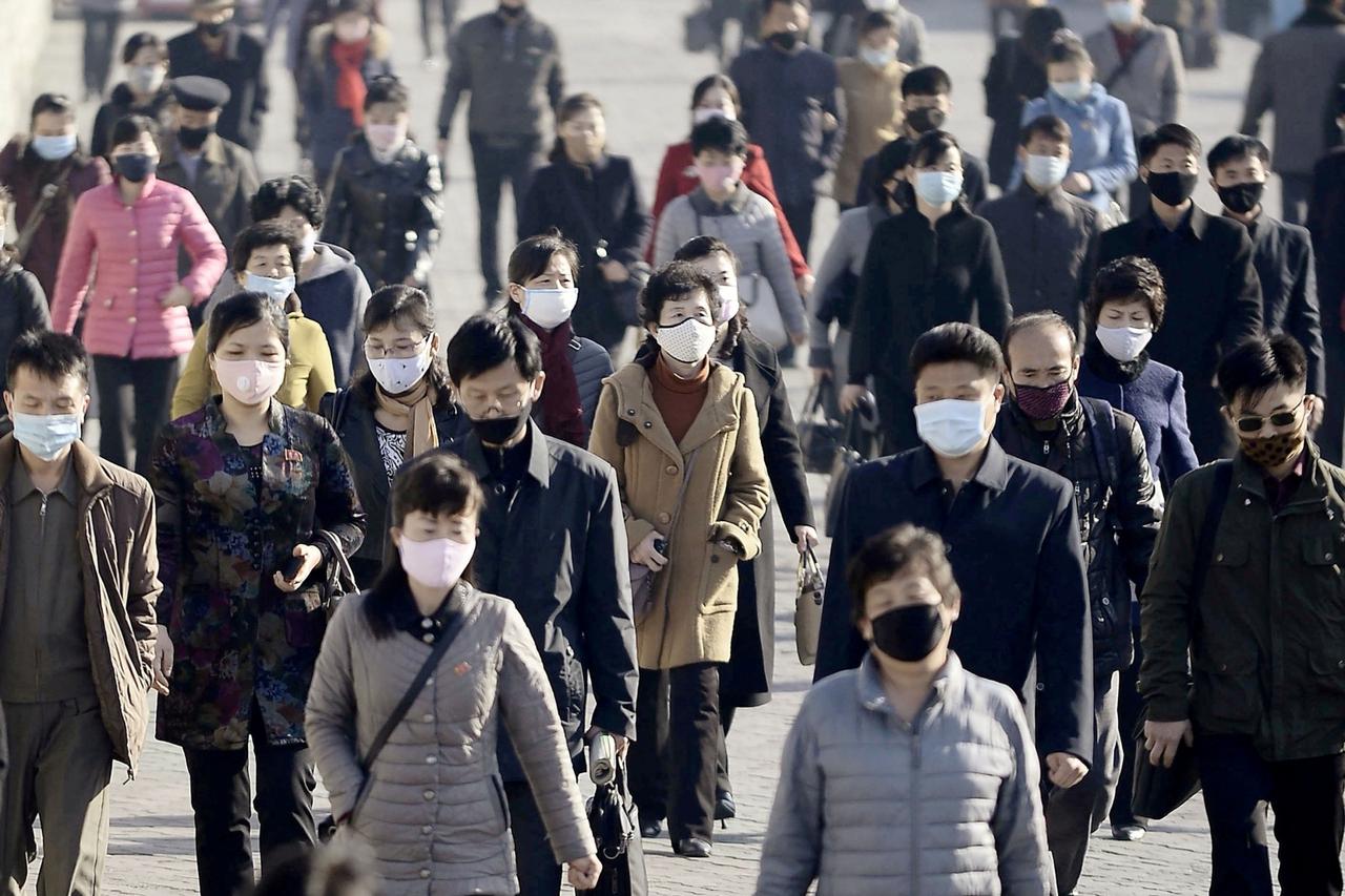 FILE PHOTO: People wearing protective face masks commute amid concerns over the new coronavirus disease in Pyongyang, North Korea