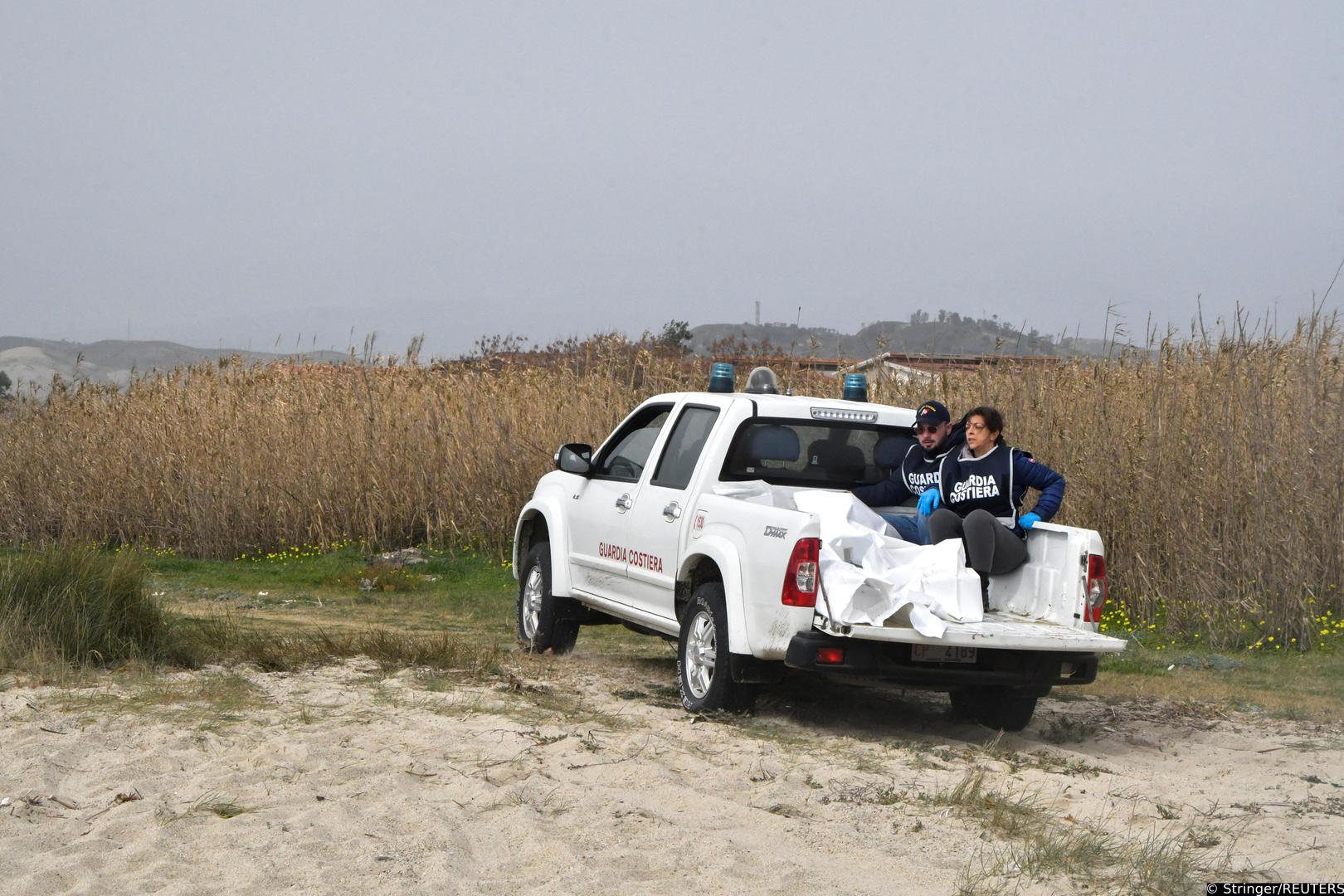 Coast guard members sit next to bodies recovered after a suspected migrant shipwreck and bodies believed to be of refugees were found in Cutro, the eastern coast of Italy's Calabria region, Italy, February 26, 2023. REUTERS/Giuseppe Pipita  NO RESALES. NO ARCHIVES Photo: Stringer/REUTERS