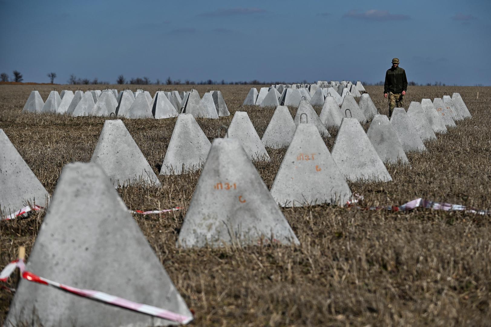 Danylo, commander of an engineering and sapper company of the Ukrainian Armed Forces, inspects pyramidal anti-tank obstacles known as 'dragon's teeth' before installing them into a new fortification line, amid Russia's attack on Ukraine, in Zaporizhzhia region, Ukraine March 11, 2024. REUTERS/Stringer Photo: Stringer/REUTERS