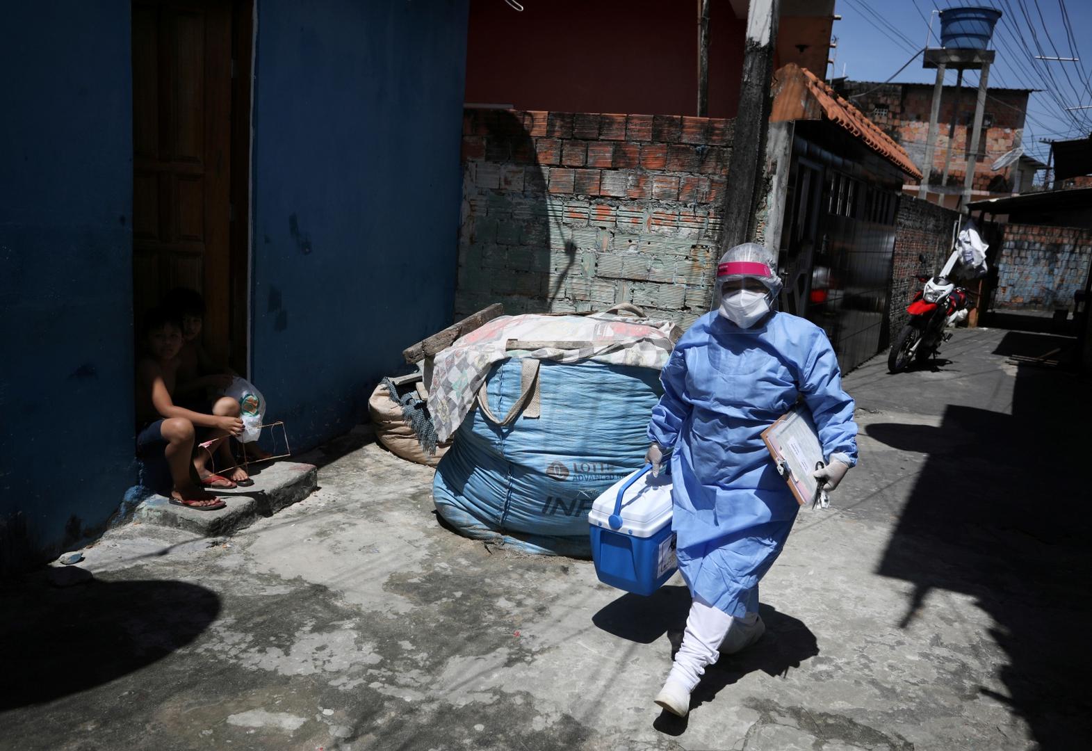 Outbreak of the coronavirus disease (COVID-19) in Manaus Municipal health worker Nicassia Brandao arrives to take samples from Vicencia Paulo de Araujo, who died at the age of 57 after reporting symptoms consistent with COVID-19, during the coronavirus disease (COVID-19) outbreak in Manaus, Brazil, May 27, 2020. REUTERS/Bruno Kelly BRUNO KELLY