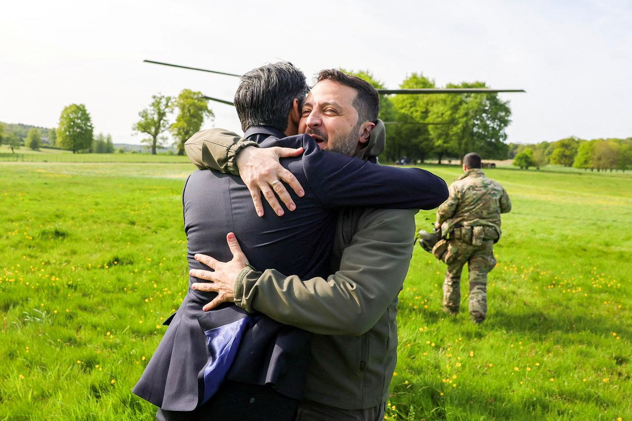 Britain's Prime Minister Rishi Sunak hugs Ukraine's President Volodymyr Zelenskiy in Aylesbury