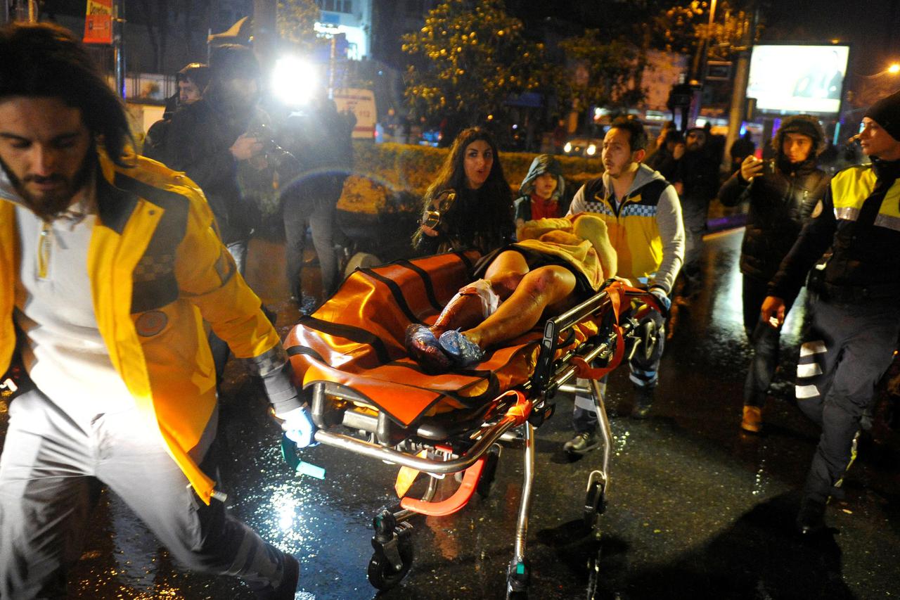 ATTENTION EDITORS - VISUAL COVERAGE OF SCENES OF INJURY OR DEATH An injured woman is carried to an ambulance from a nightclub where a gun attack took place during a New Year party in Istanbul, Turkey, January 1, 2017. Murat Ergin/Ihlas News Agency via REU