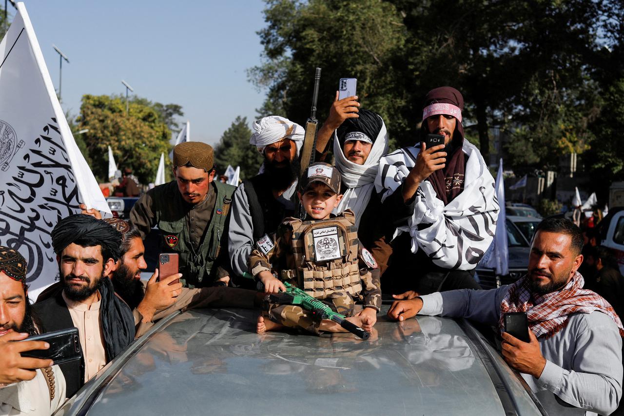 Taliban supporters celebrate on the second anniversary of the fall of Kabul at a street near the U.S. embassy in Kabul, Afghanistan