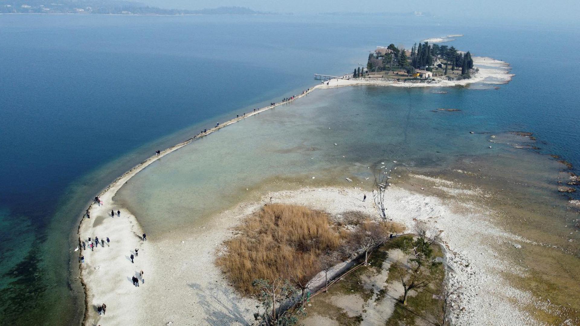 FILE PHOTO: A drone image shows San Biagio island, affected by drought in Lake Garda, near Lido di Manerba, Italy, February 21, 2023. REUTERS/Alex Fraser/File Photo Photo: ALEX FRASER/REUTERS
