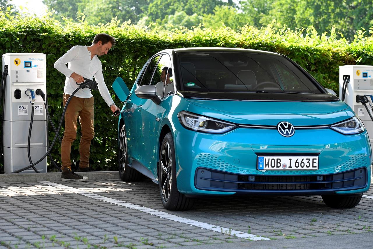 FILE PHOTO: A man charges an electric Volkswagen ID.3 car