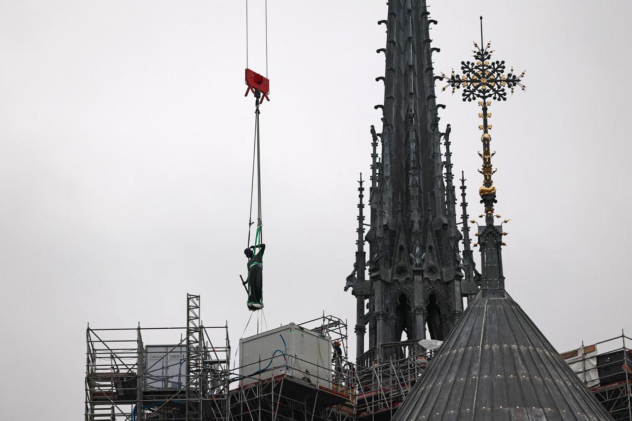 Statue of Apostle Saint Thomas installed on spire of Notre-Dame de Paris Cathedral