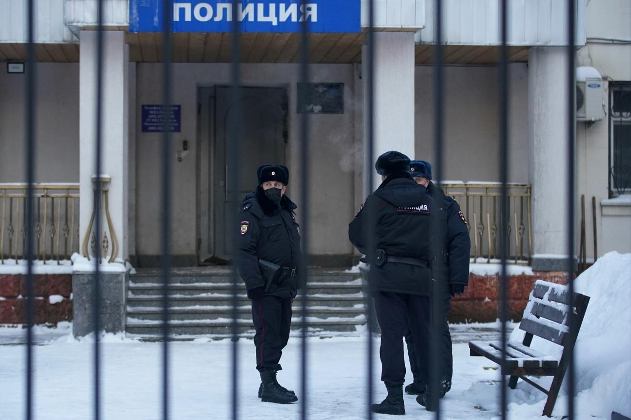 FILE PHOTO: Police officers stand outside a police station where detained Russian opposition leader Navalny is being held, in Khimki