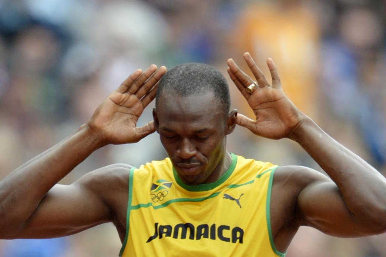 'Jamaica\'s Usain Bolt gestures before the men\'s 200m heats at the athletics event during the London 2012 Olympic Games on August 7, 2012 in London.  AFP PHOTO / ERIC FEFERBERG '