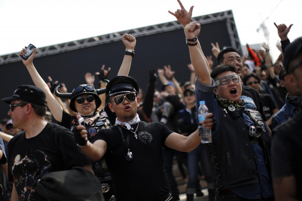 'Harley Davidson riders attend at the annual Harley Davidson National Rally in Qian Dao Lake, in Zhejiang Province May 11, 2013. Around 1,000 Harley Davidson enthusiasts from all over China met to cel