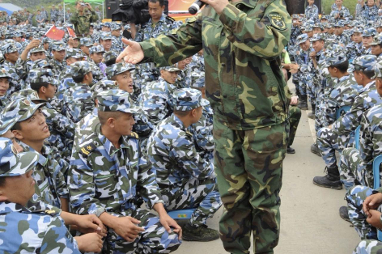 'China's new first lady and singer Peng Liyuan sings during a performance as she visits soldiers and residents after the Wenchuan earthquake in Deyang, Sichuan province June 21, 2008. Peng is best kn
