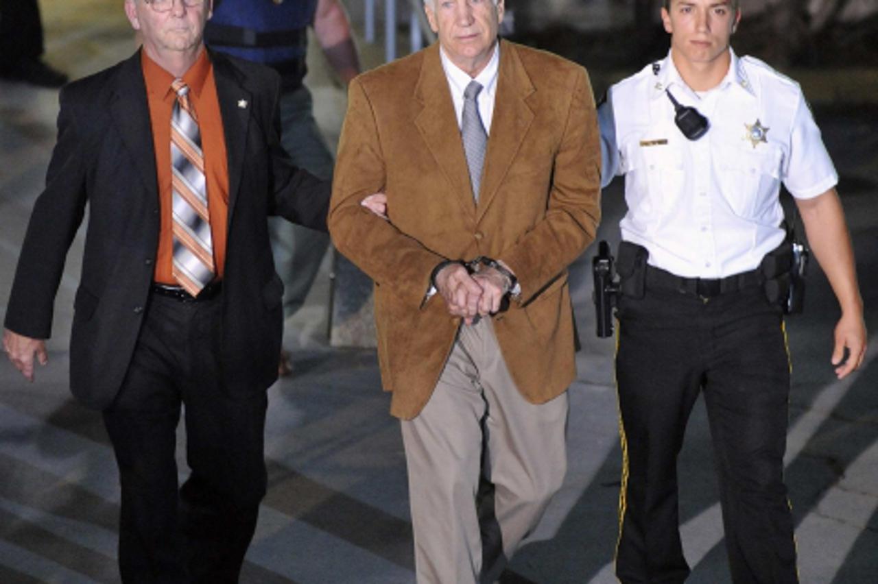 'Former Penn State assistant football coach Jerry Sandusky leaves the Centre County Courthouse in handcuffs after his conviction in his child sex abuse trial in Bellefonte, Pennsylvania, June 22, 2012
