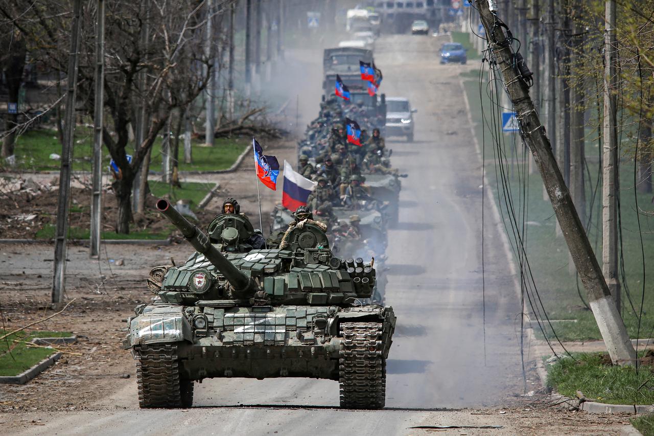 FILE PHOTO: An armoured convoy of pro-Russian troops moves along a road in Mariupol