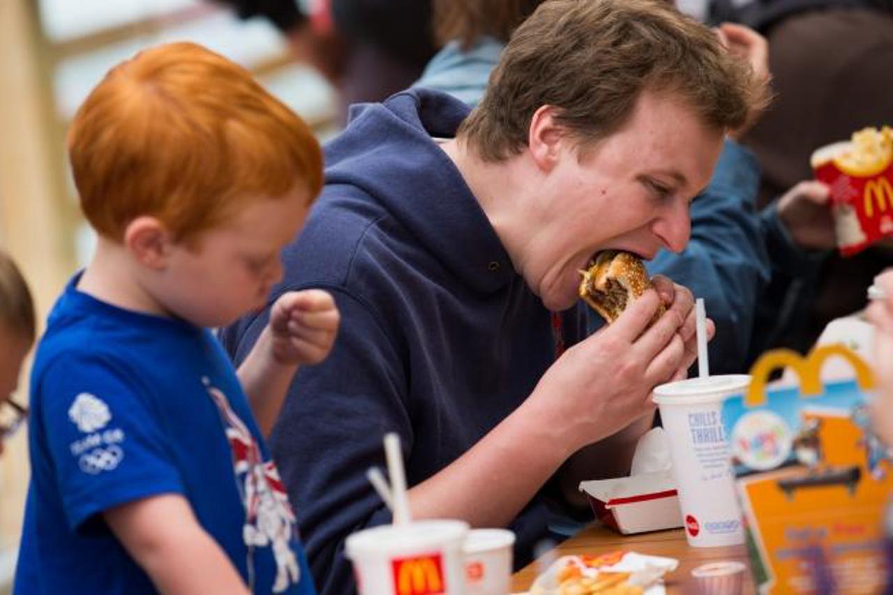 'Fans eating lunch at McDonalds, one of the main sponsors of the Olympics, at the Olympic Park. Credit: The Times Online rights must be cleared by N.I.Syndication Photo: NI Syndication/PIXSELL'