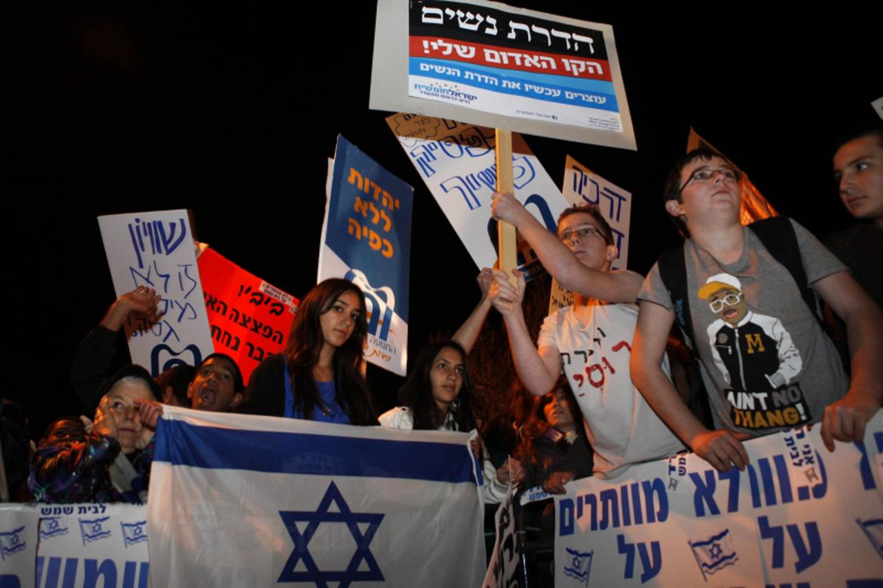 'Israelis protest against gender segregation and violence towards women by ultra Orthodox Jewish extremists on December 27, 2011 in the town of Beit Shemesh, near Jerusalem. The protest comes after a 