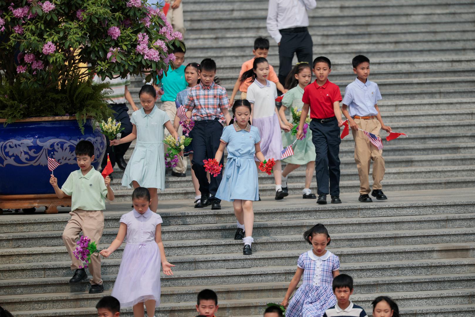 Children holding either U.S. and Chinese flags or flowers run ahead of U.S. President Donald Trump's arrival for a welcoming ceremony at the Great Hall of the People in Beijing, China, May 14, 2026. REUTERS/Evan Vucci Photo: Evan Vucci/REUTERS