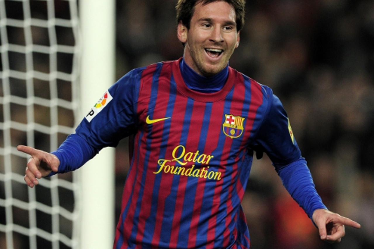 'Barcelona\'s Argentinian forward Lionel Messi celebrates after scoring during the Spanish Cup football match FC Barcelona vs Osasuna on January 4, 2012 at the Camp Nou stadium in Barcelona.    AFP PH