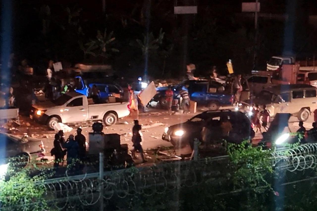 People take part in looting and arson amid protests over a pay cut for police that officials blamed on an administrative glitch, in Port Moresby