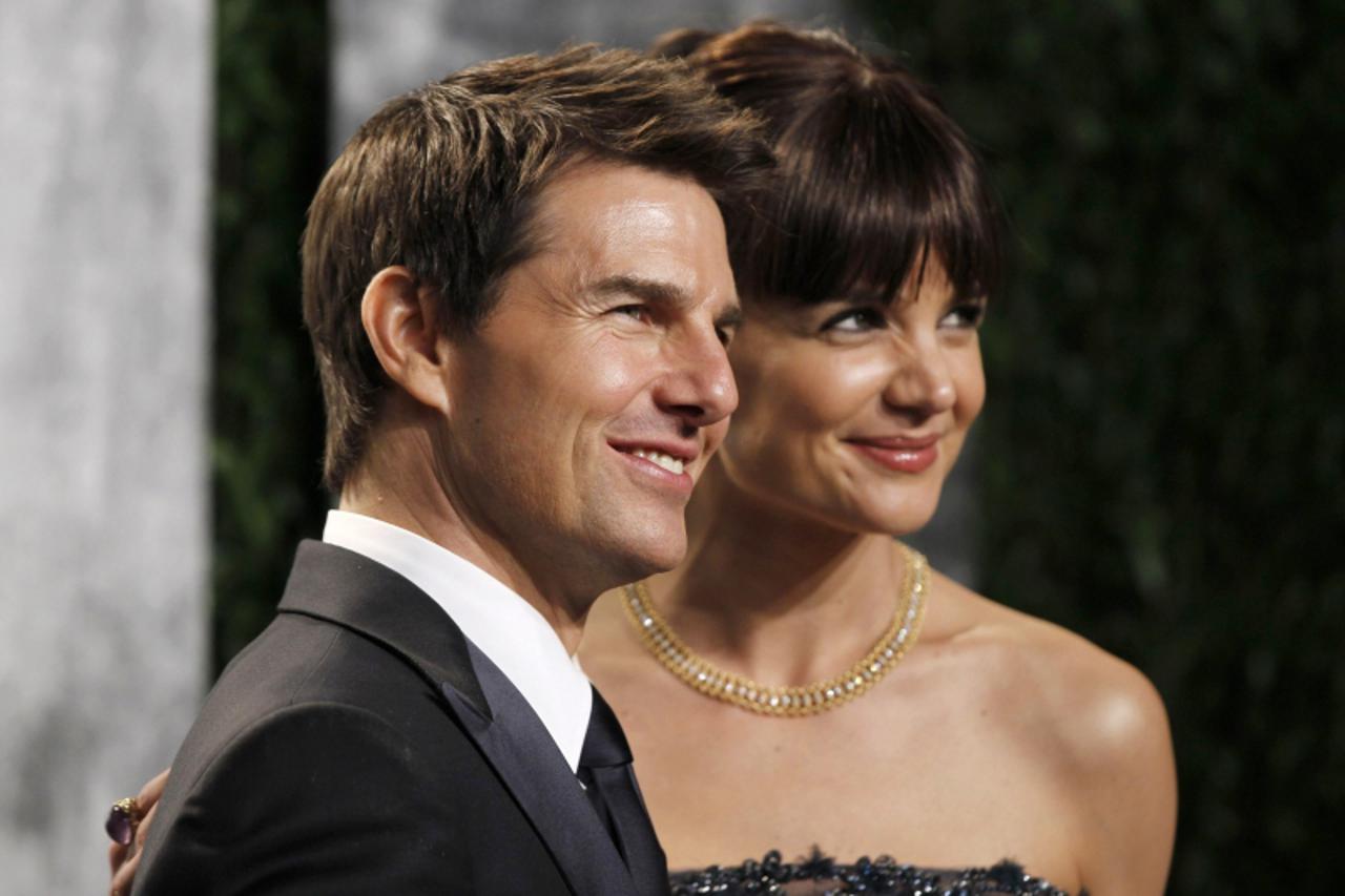 'Actor Tom Cruise and his wife, actress Katie Holmes, arrive at the 2012 Vanity Fair Oscar party in West Hollywood, California February 26, 2012.  REUTERS/Danny Moloshok (UNITED STATES  - Tags: ENTERT