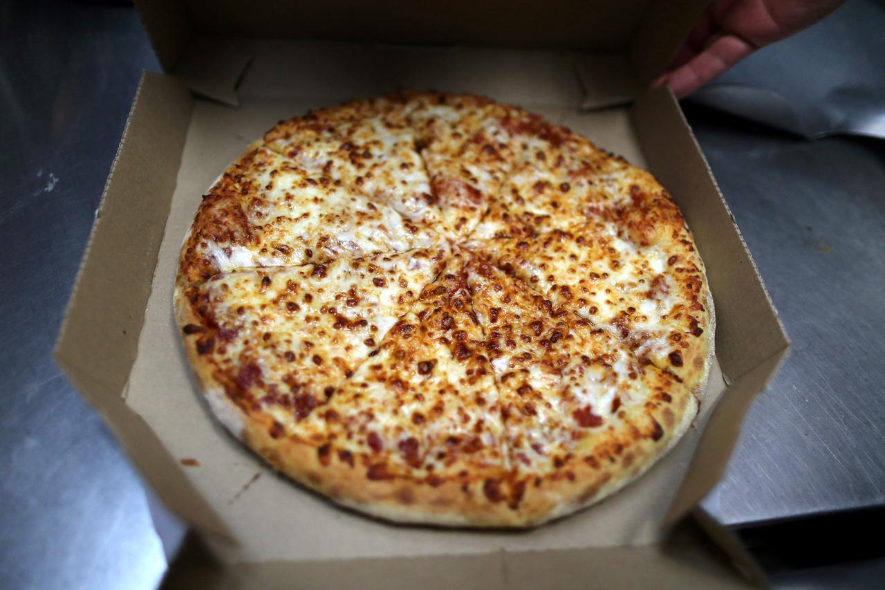 FILE PHOTO: A pizza comes out of the oven at Domino's Pizza restaurant in Los Angeles