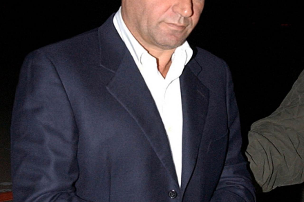 \'Croatian General Ante Gotovina is escorted towards a police vehicle on arrival at the Torrejon military air base outside Madrid December 8, 2005. Gotovina, one of the three most wanted war crimes su