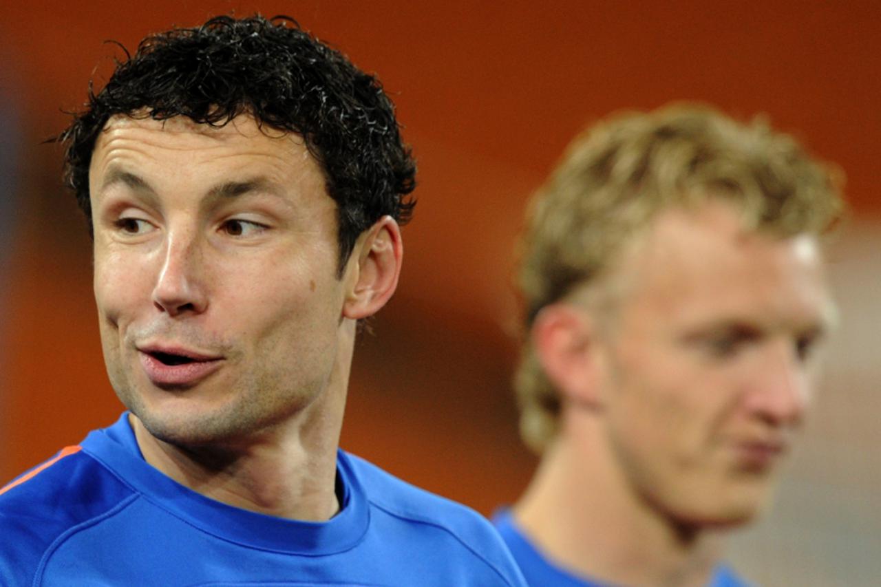 'Netherlands\' midfielder Mark van Bommel (R) and Netherlands\' striker Dirk Kuyt take part in an official training session at Soccer City stadium in Soweto, suburban Johannesburg, on July 10, 2010 a 