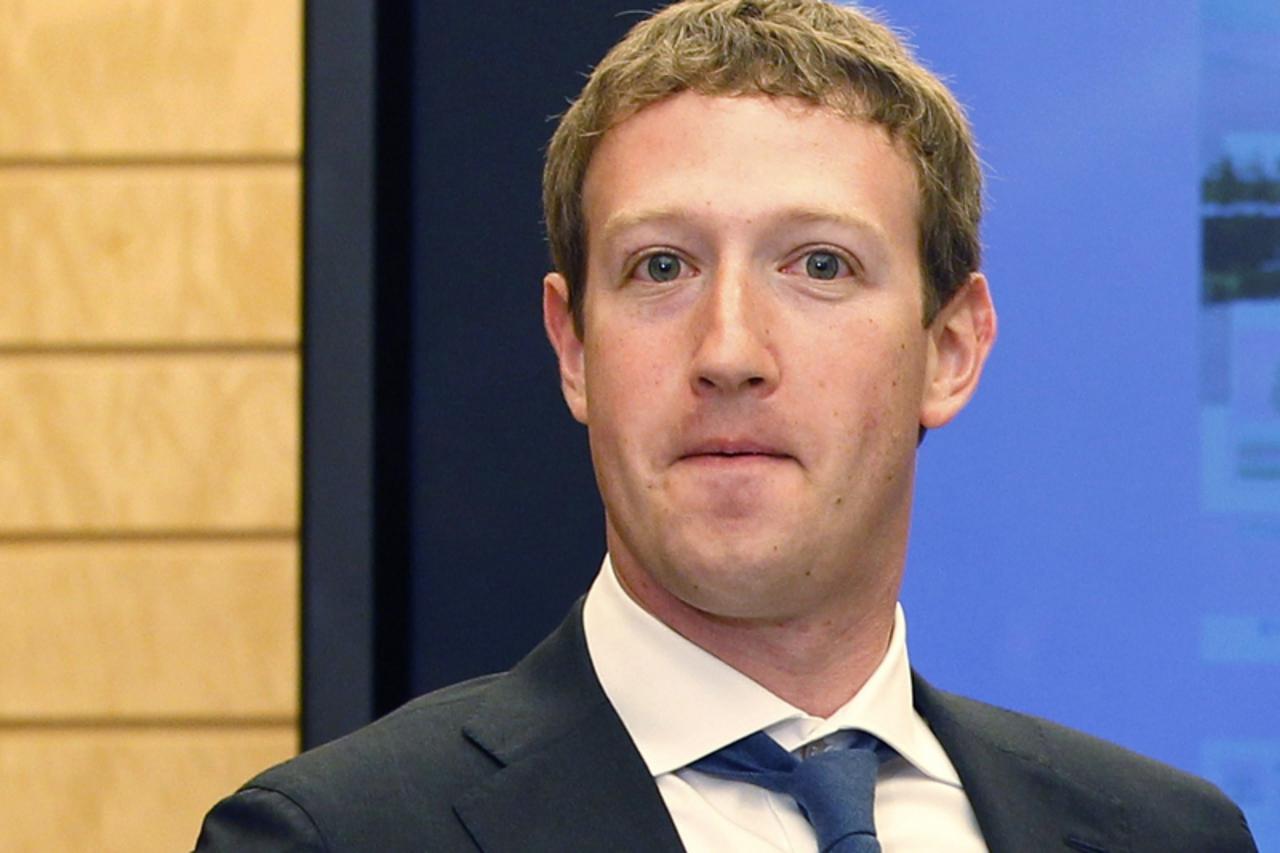 'Facebook CEO Mark Zuckerberg waits for Japanese Prime Minister Yoshihiko Noda before a meeting at the official residence in Tokyo in this file photo taken March 29, 2012.  Facebook, founded eight yea