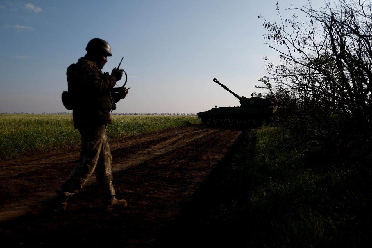 Ukrainian servicemen prepare a self-propelled howitzer to fire toward Russian positions on a frontline in Mykolaiv region