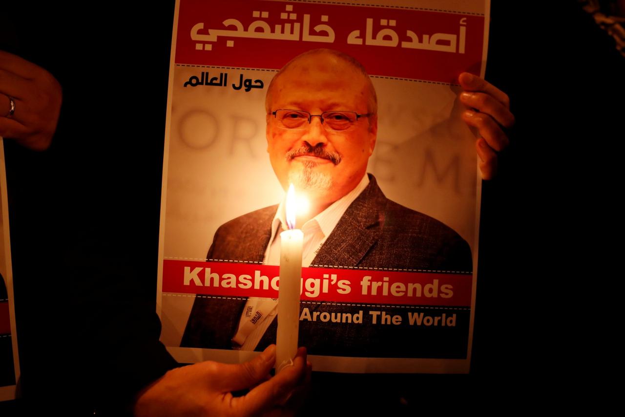FILE PHOTO: A demonstrator holds a poster with a picture of Saudi journalist Jamal Khashoggi outside the Saudi Arabia consulate in Istanbul