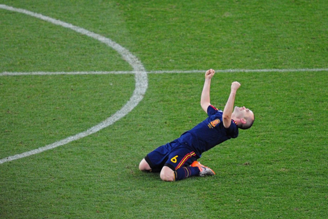 'Spain\'s midfielder Andre\\u0301s Iniesta celebrates at the end of the 2010 football World Cup final between the Netherlands and Spain on July 11, 2010 at Soccer City stadium in Soweto, suburban Joha
