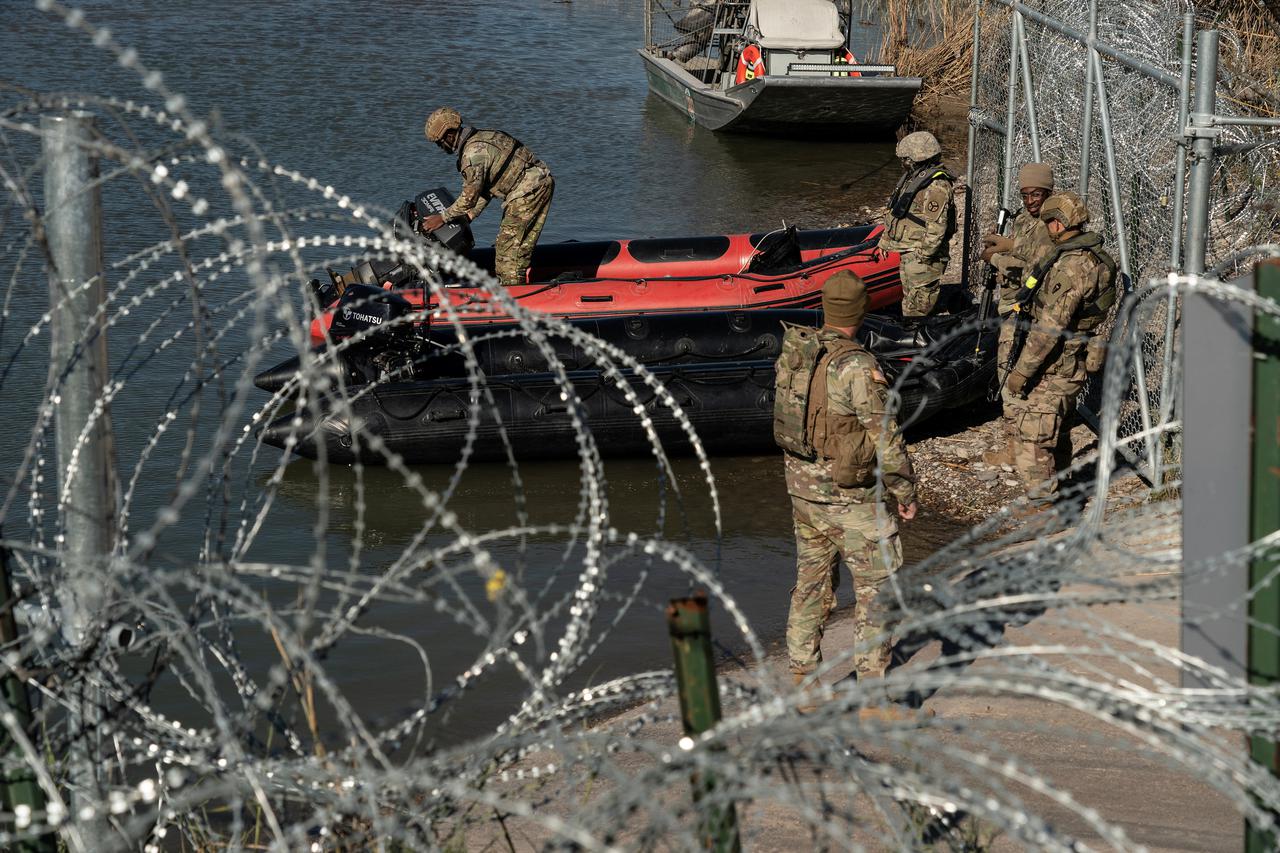 Migrants cross the border into Texas from Mexico
