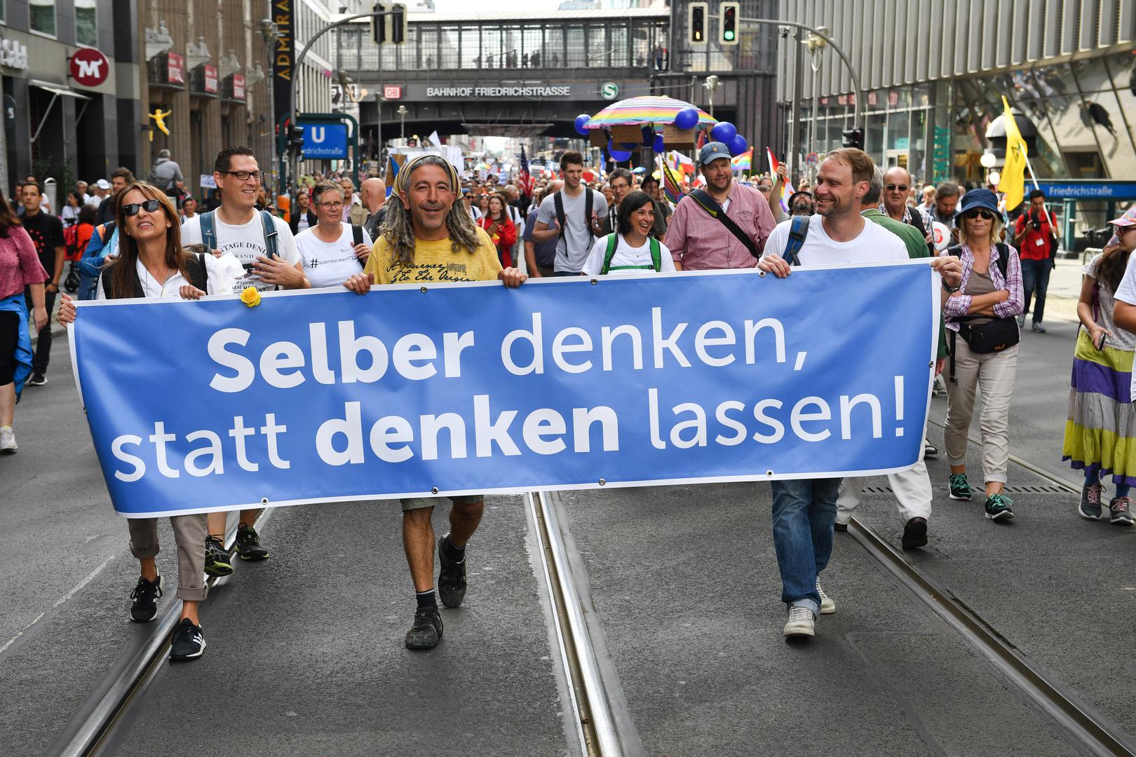 29 August 2020, Berlin: Participants walk through Freidrichstraße during a demonstration against the Corona measures with a banner "Think for yourself, don't let others think! Photo: Bernd Von Jutrczenka/dpa /DPA/PIXSELL