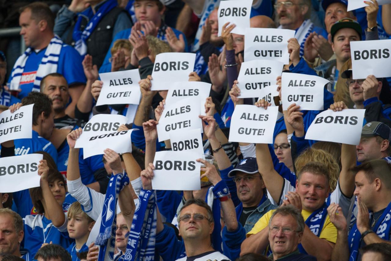 'Supporters of Hoffenheim hold up posters to wish all the best to their Croatian-born midfielder Boris Vukcevic, who suffered from severe injuries as he had a car accident the day before, prior to the