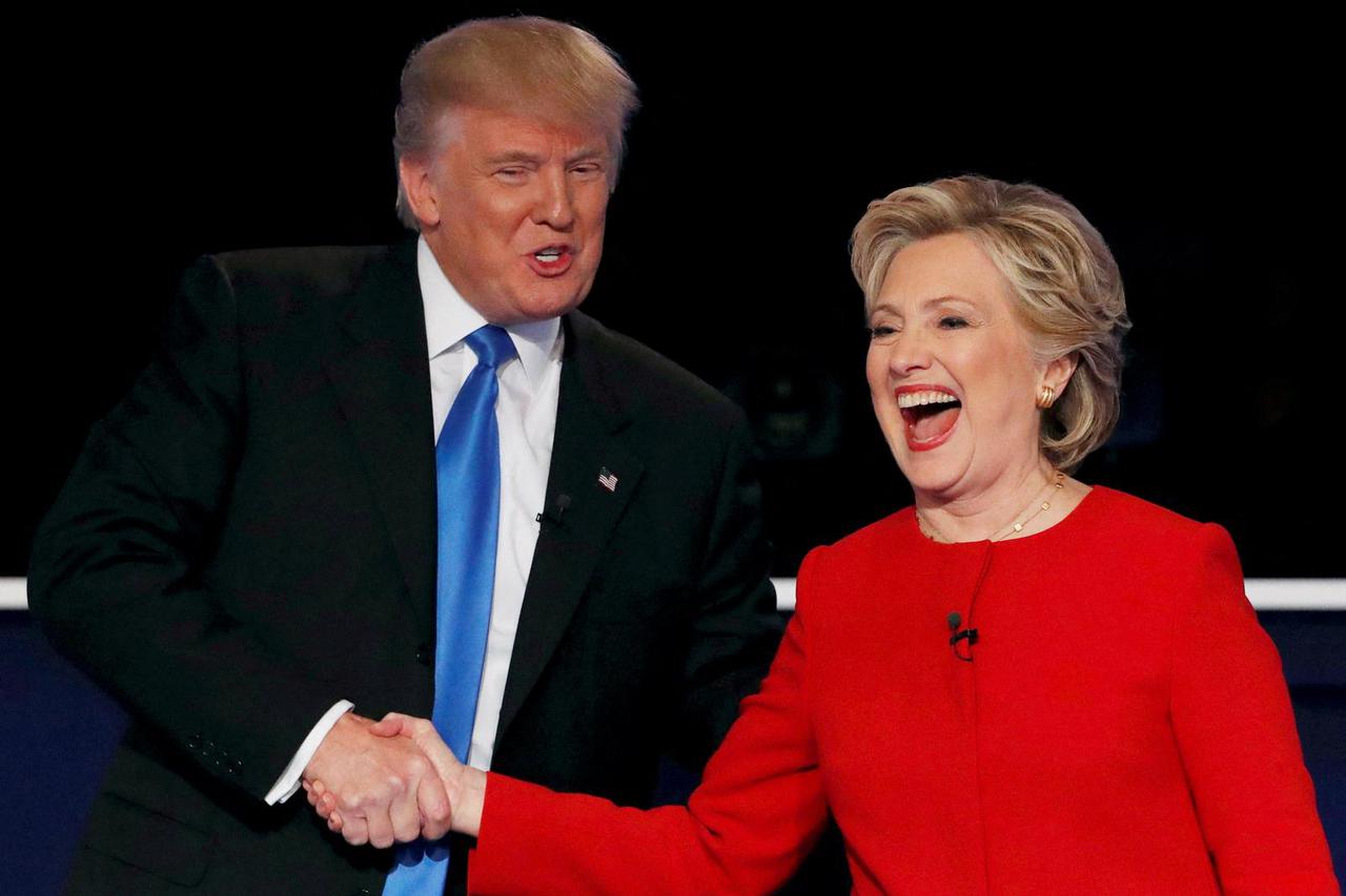FILE PHOTO: Republican U.S. presidential nominee Donald Trump shakes hands with Democratic U.S. presidential nominee Hillary Clinton at the conclusion of their first presidential debate at Hofstra University in Hempstead