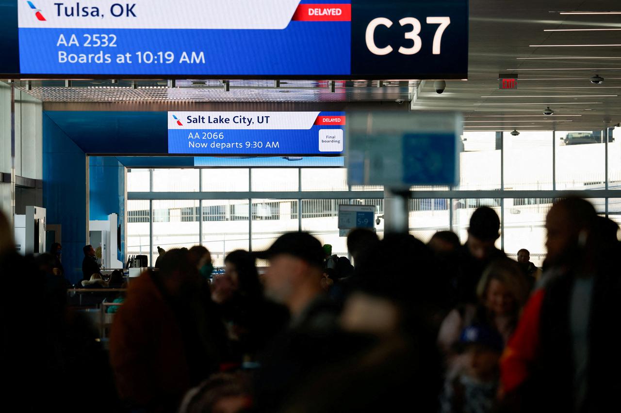 FILE PHOTO: Screens display flight information in Dallas Fort Worth Airport