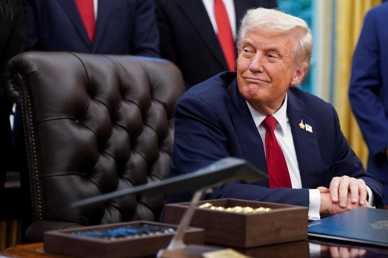 U.S. President Donald Trump signs an executive order in the Oval Office of the White House