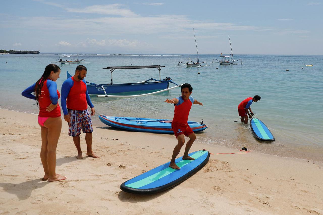 FILE PHOTO: Tourists enjoy the beach in Nusa Dua, Bali