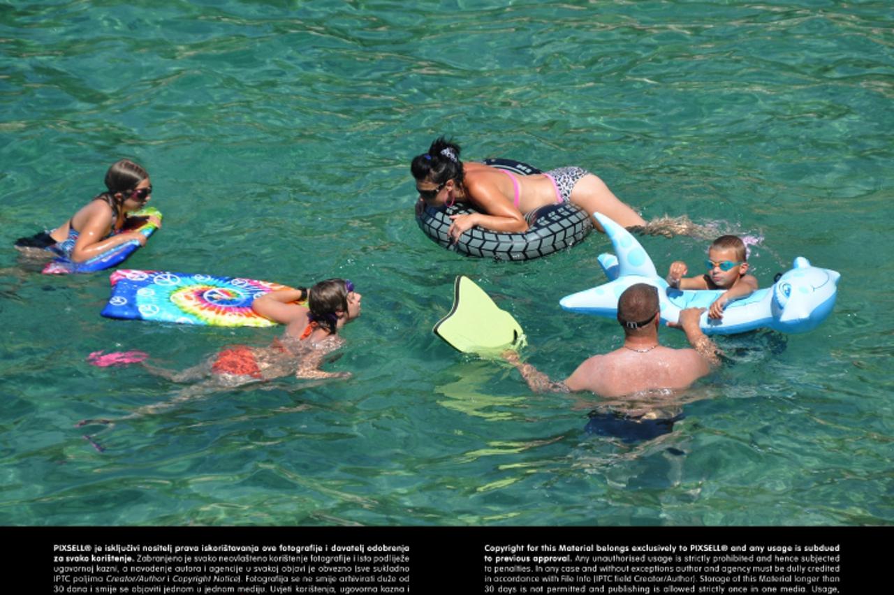 '08.07.2012., Pula - Ljetni dan na pulskim plazama, turisti uzivaju u kupanju i suncanju. Obitelj na godisnjem odmoru. PRI KORISTENJU FOTOGRAFIJE ZASTITITI IDENTITET DJETETA (PREKRITI OCI) Photo: Dusk
