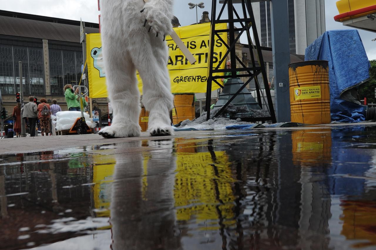 An activist of Greenpeace costumed as polar bear demonstrates against oil drilling in the Arctic Zone in front of a petrol station of Shell in Hamburg, Germany, 14 July 2012. According to Greenpeace, the protest actions against Shell take place in 40 citi