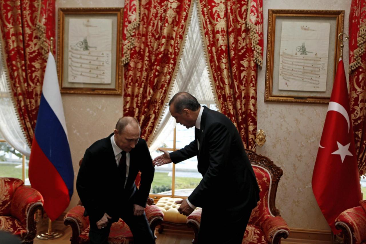 'Turkey's Prime Minister Tayyip Erdogan gestures as Russia's President Vladimir Putin prepares to sit during their meeting in Istanbul December 3, 2012. Three Russian government sources told Reuters