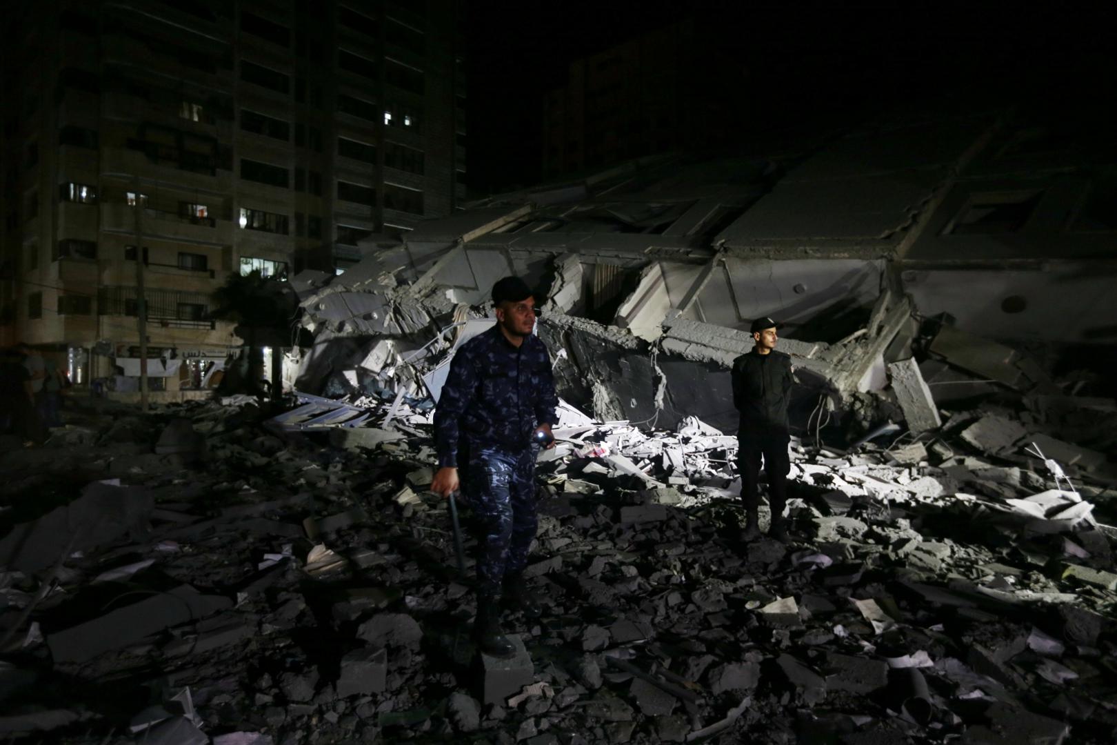 Israeli-Palestinian violence flares up Palestinian policemen stand at the site where a building was destroyed by Israeli air strikes amid a flare-up of Israeli-Palestinian violence, in Gaza City May 11, 2021. REUTERS/Ibraheem Abu Mustafa IBRAHEEM ABU MUSTAFA