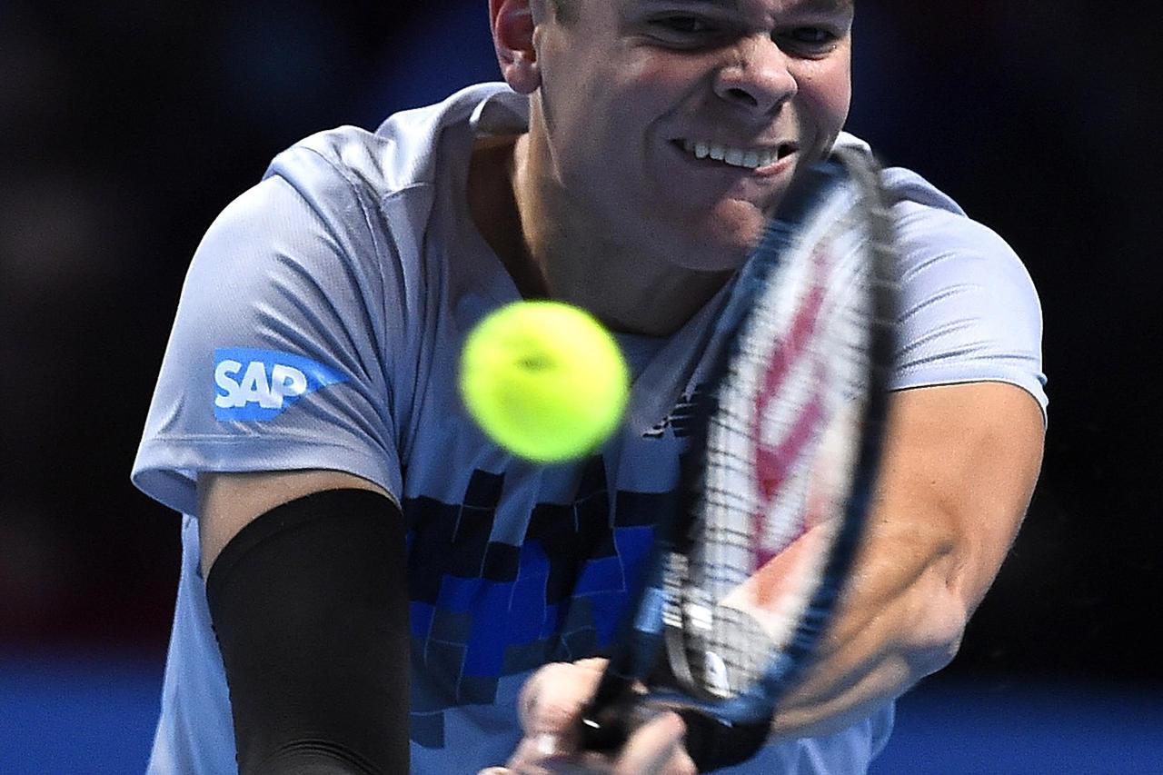 Milos Raonic of Canada plays a return during his men's singles tennis match against Roger Federer of Switzerland at the ATP World Tour Finals at the O2 Arena in London November 9, 2014.   REUTERS/Dylan Martinez (BRITAIN - Tags: SPORT TENNIS)
