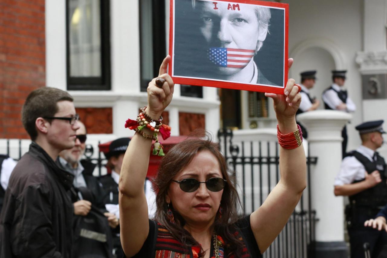 'A placard is held by a supporter of Julian Assange outside the Equador embassy in west London, August 16, 2012. Ecuador has granted political asylum to WikiLeaks' founder Julian Assange, Foreign Min