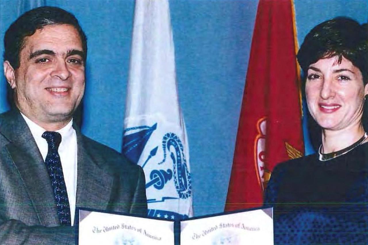 An undated handout image shows Ana Belen Montes receiving a national intelligence certificate of distinction from George Tenet